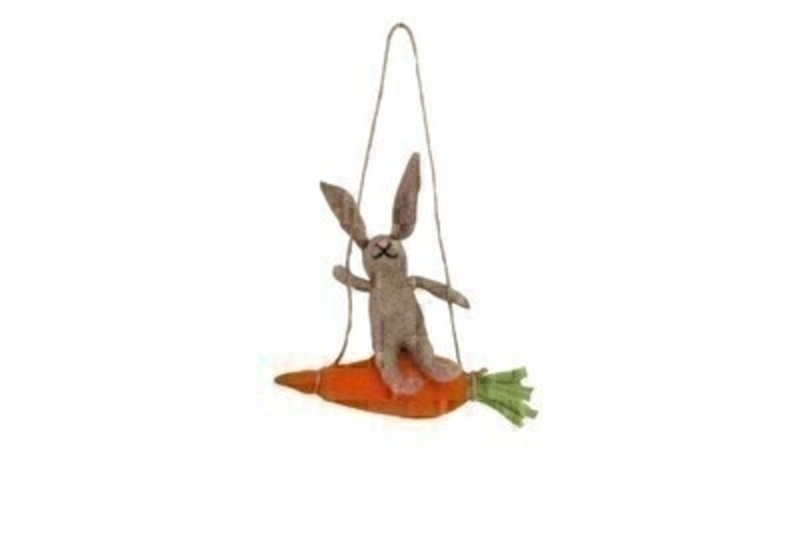 Easter bunny sitting on a carrot swing made from wool mix by designer Gisela Graham who designs unique Easter gifts and decorations. This would look lovely hanging on your Easter Tree.